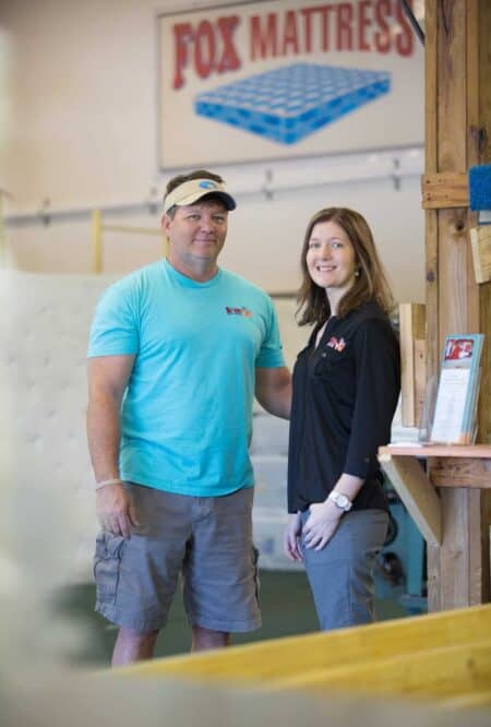 Friendly staff members at Fox Mattress store, showcasing quality mattresses and customer service in a welcoming retail environment.
