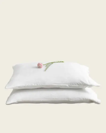 Pillow with flower, natural sleep support, mattress underground, sleep health tips, quality pillow for better rest.