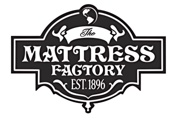 Black and white logo of The Mattress Factory with vintage font and decorative elements, signifying quality mattress craftsmanship since 1896.